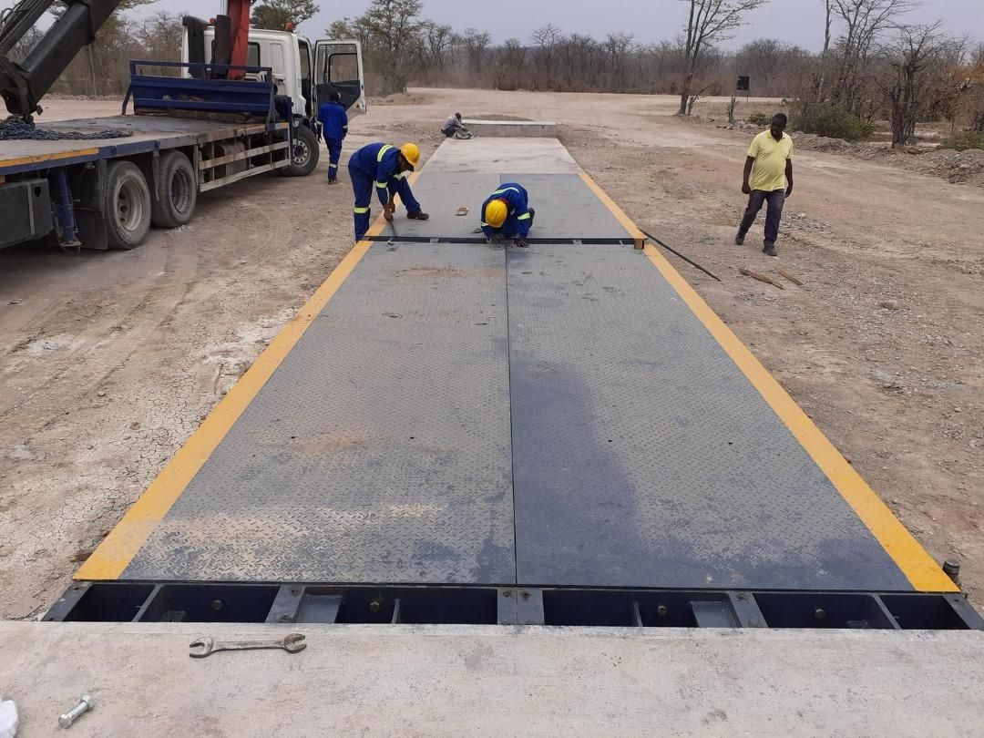 Premier Scales technicians aligning the deck sections of a new weighbridge